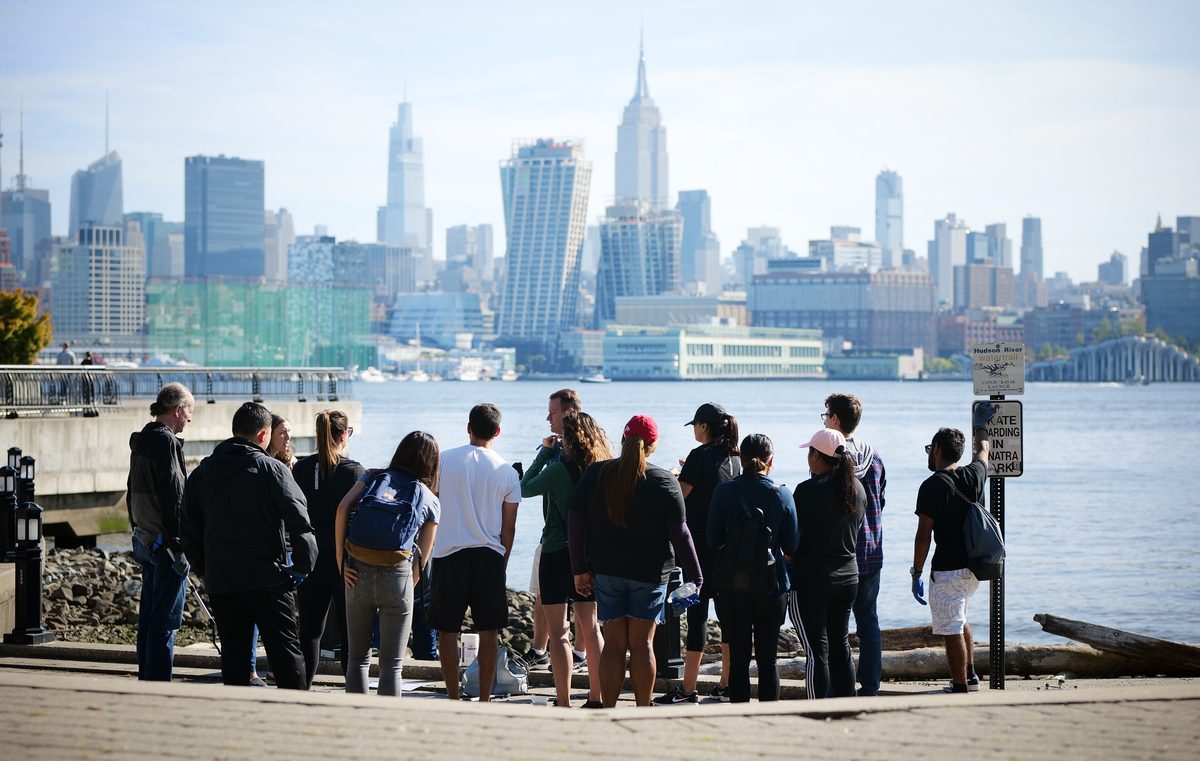 Hoboken Grace volunteers gathered along the waterfront with the NYC skyline