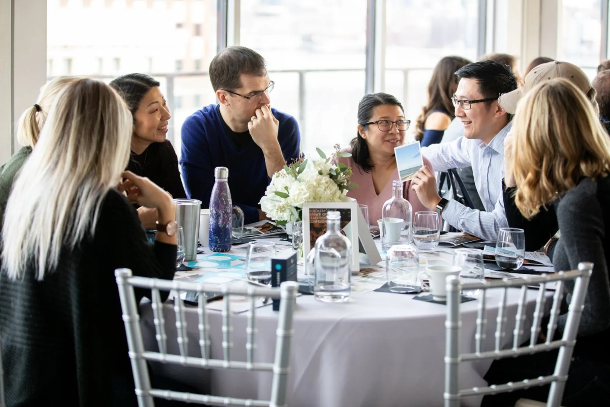Dinner group leaders talking around a table at the Better Together leadership conference